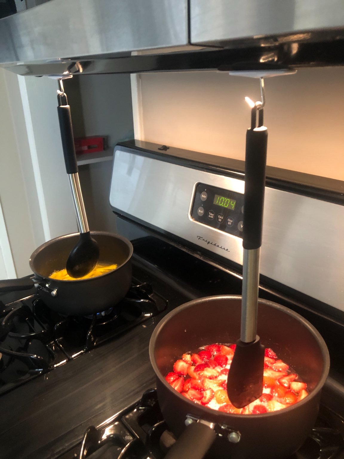 A shot of lemon syrup and strawberry syrup in progress. Hanging your utensils directly over the pots and pans saves some cleaning.